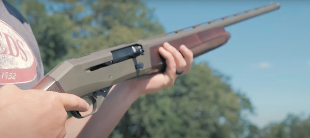 A man holding a shotgun in his hands