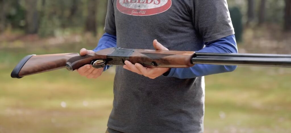 Man holding a shotgun in his hands