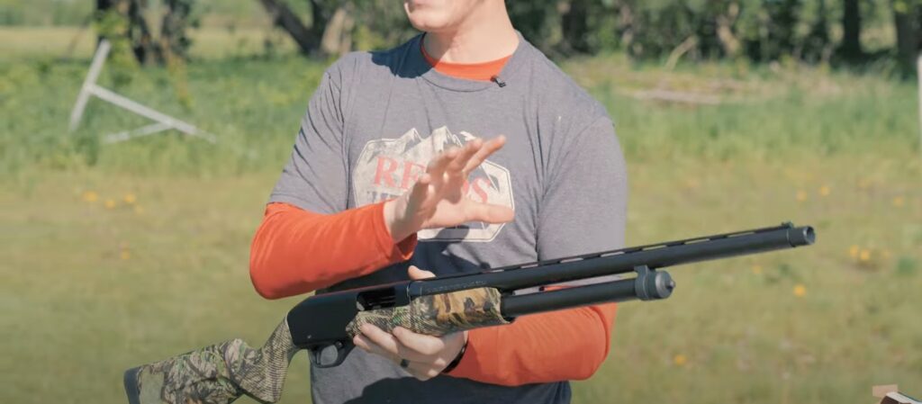 A man holding a shotgun in his hands